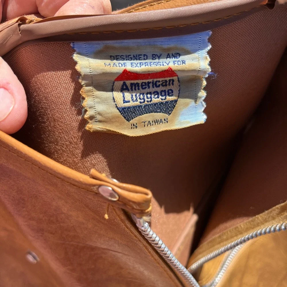 Vintage leather carry on for hanging clothes.